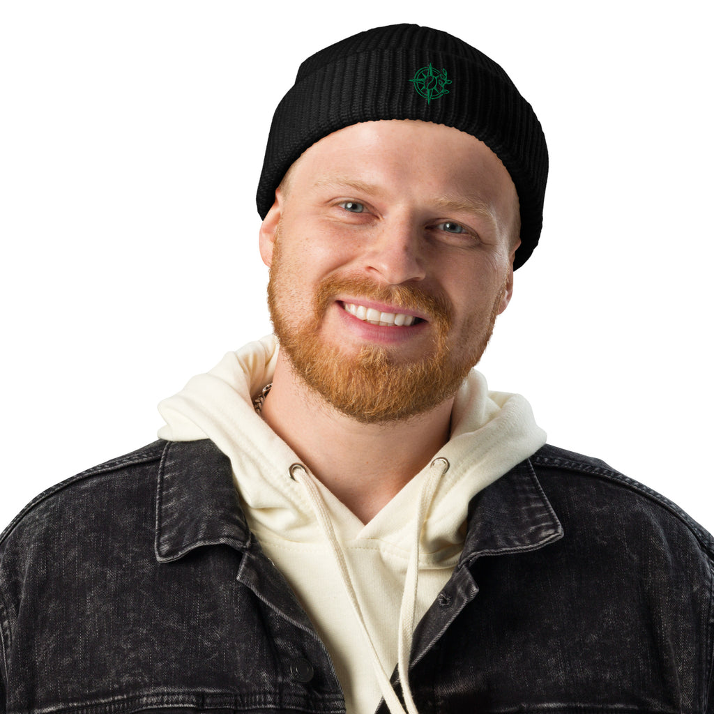 Man wearing a black beanie with 'Levi's' logo and a denim jacket over a white hoodie on a white background.