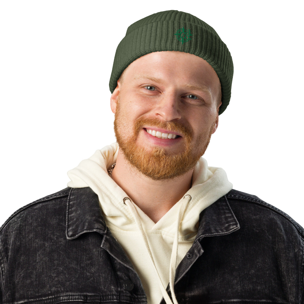 Man wearing a brown beanie with a logo and a denim jacket over a white hoodie on a white background