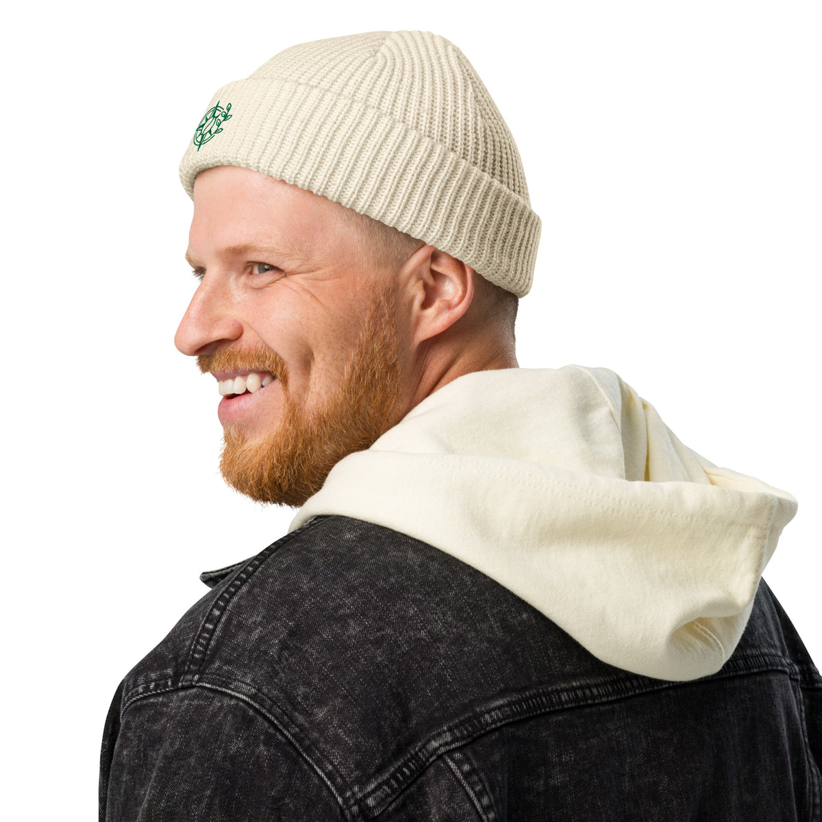 Man wearing a beige beanie and black jacket with white hood on a white background