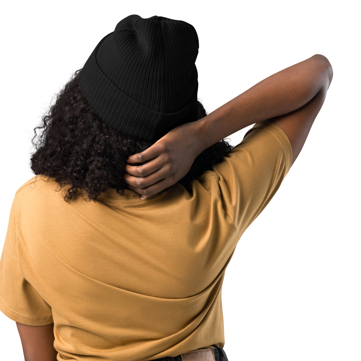 Person wearing a black beanie and mustard yellow shirt on a white background