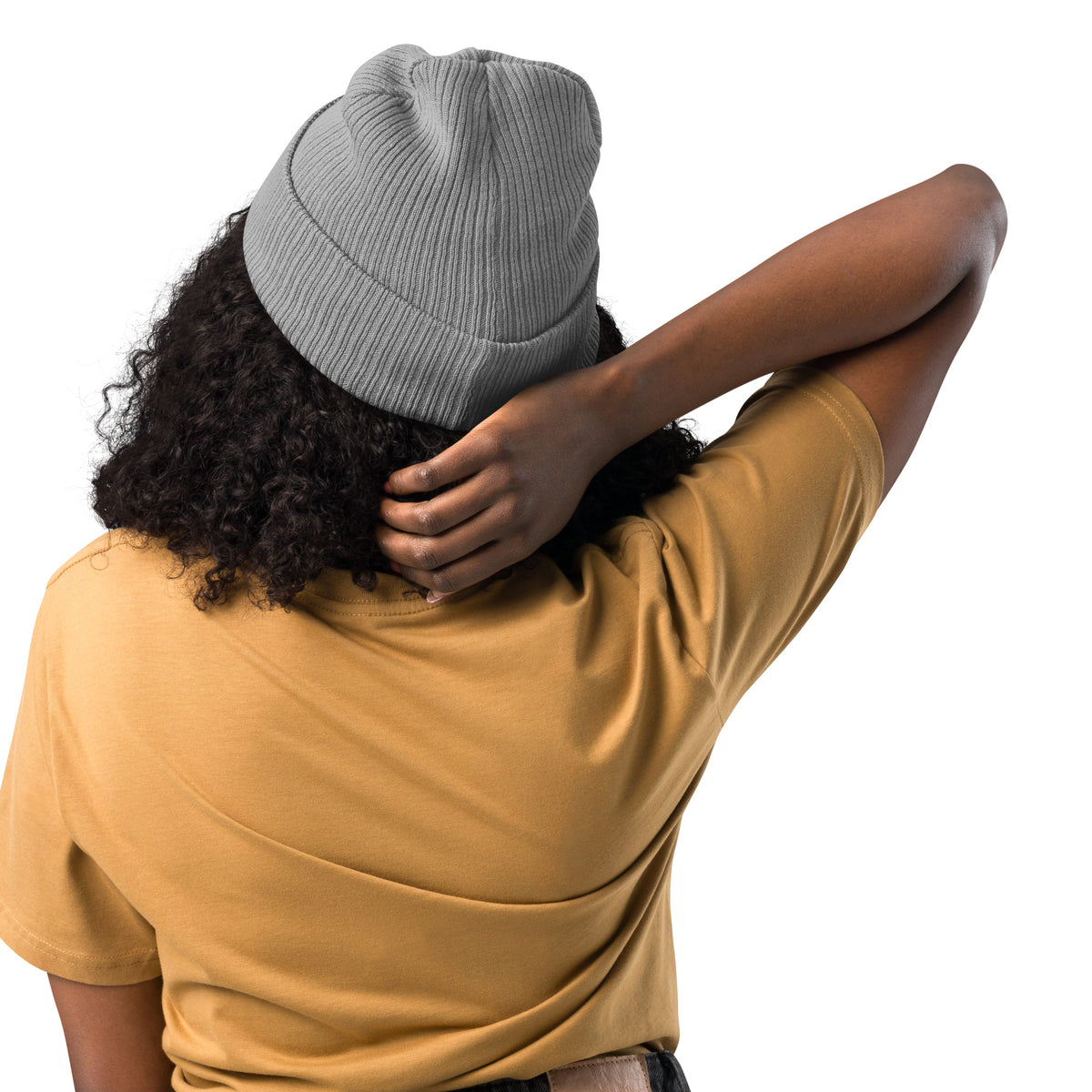 Person wearing a gray beanie and yellow shirt with one arm around their head on a white background