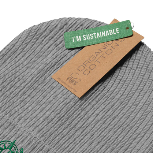 Close-up of a gray ribbed knit beanie with a brown paper tag reading 'ORGANIC COTTON' and a green tag reading 'I'M SUSTAINABLE' on a white background.