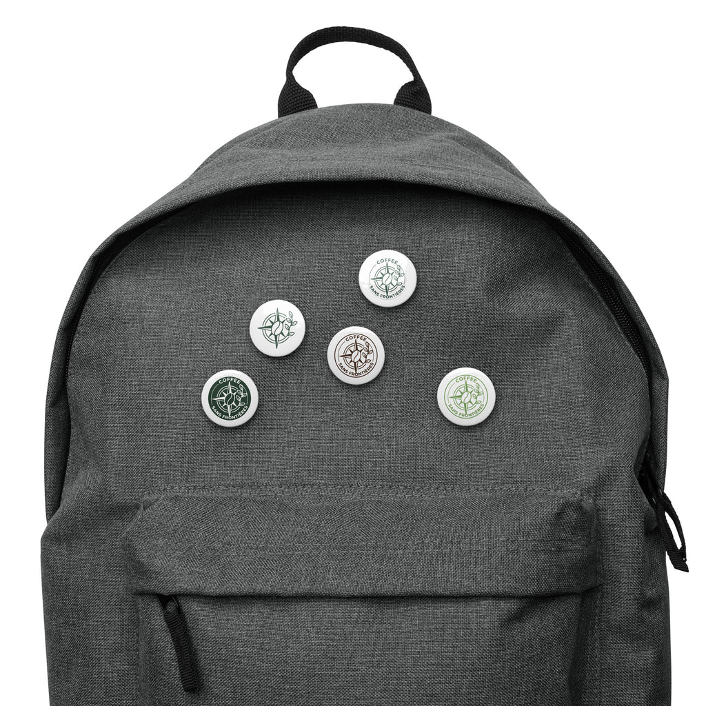 Gray backpack with various pins on a white background