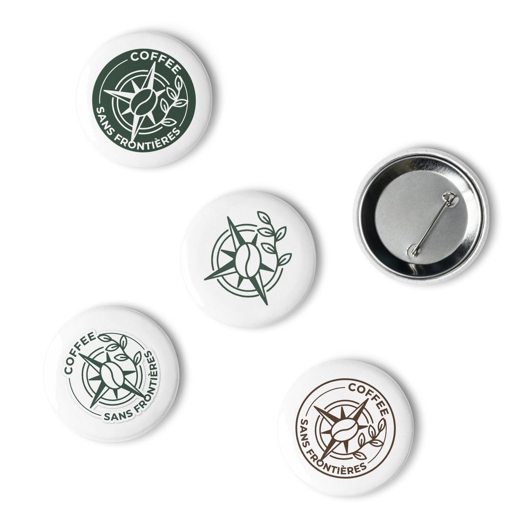 Five round pin-back buttons with coffee-themed graphics on a white background, including one back view showing the metal pin fastener.